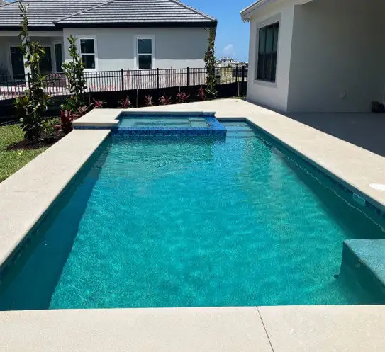 Pool/jacuzzi combo in a sunny backyard